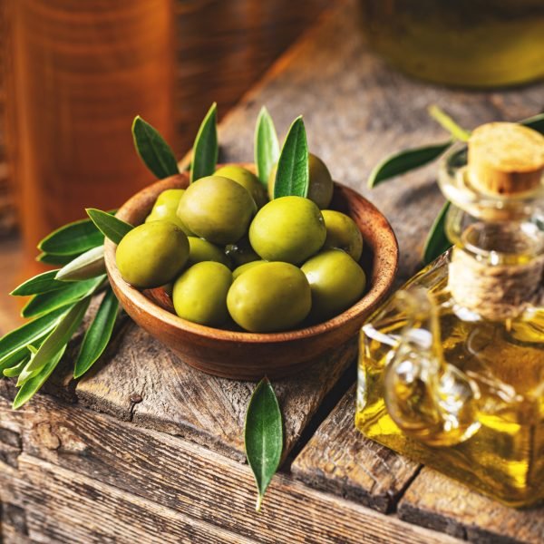 Image of olives and olive oil in rustic style, still life